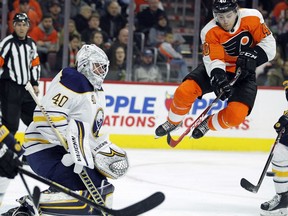 Philadelphia Flyers' Jordan Weal, right, leaps after screening a shot against Buffalo Sabres' goalie Robin Lehner (40) during the second period of an NHL hockey game, Sunday, Jan. 7, 2018, in Philadelphia.