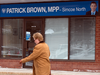 A woman walks by the Orillia office of former Ontario Progressive Conservative leader Patrick Brown who resigned amidst sexual misconduct allegations, Jan. 25, 2018.