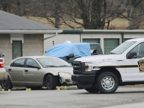 Evidence markers sit on the scene of a fatal shooting at a car wash in Melcroft, Pa., Sunday, Jan. 28, 2018.