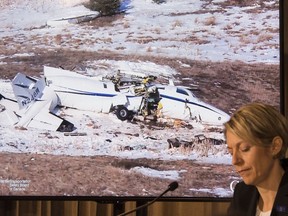 A photo of the ill-fated Mitsubishi MU-2B-60 aircraft is seen after crashing at the Iles-de-la-Madeleine as Natacha Van Themsche, TSB director of air investigations looks on, Wednesday, January 10, 2018 in Montreal. The March 2016 accident claimed the lives of seven people - the two pilots as well as Lapierre, his wife and three of his siblings.