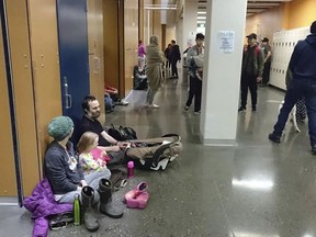Evacuees gather at Kodiak High School in Kodiak, Alaska, Tuesday, Jan 23, 2018, after an earthquake and tsunami alert. A powerful undersea earthquake sent Alaskans fumbling for suitcases and racing to evacuation centers in the middle of the night Tuesday after a cellphone alert warned that a tsunami could smash into the state's southern coast and western Canada.