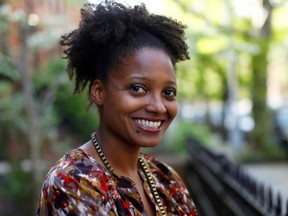 FILE - In this April 16, 2012 file photo, Pulitzer Prize winning poet Tracy K. Smith poses outside her apartment in New York. Smith has embarked on the first of several trips to bring her poetry to rural pockets of the country where she says book festivals rarely take her.