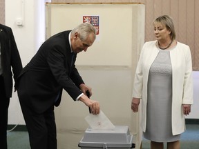 Czech Republic's President Milos Zeman accompanied by his wife Ivana casts his vote during second round of Presidential elections in Prague, Czech Republic, Friday, Jan. 26, 2018. The pro-Russian incumbent Zeman faces the former head of the Academy of Sciences Jiri Drahos in the Czech Republic's tight presidential runoff vote.