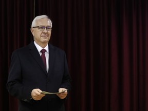 Presidential candidate Jiri Drahos prepares to cast a vote during first round of Presidential elections in Prague, Czech Republic, Friday, Jan. 12, 2018.