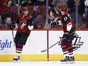 Arizona Coyotes center Nick Cousins (25) celebrates his goal against the New York Islanders with defenseman Oliver Ekman-Larsson (23) during the first period of an NHL hockey game, Monday, Jan. 22, 2018, in Glendale, Ariz.