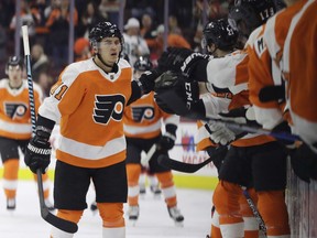 Philadelphia Flyers' Travis Konecny celebrates with teammates after scoring a goal during the first period of an NHL hockey game against the New Jersey Devils, Saturday, Jan. 20, 2018, in Philadelphia.