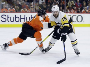 Pittsburgh Penguins' Riley Sheahan, right, tries to get past Philadelphia Flyers' Radko Gudas during the first period of an NHL hockey game, Tuesday, Jan. 2, 2018, in Philadelphia.