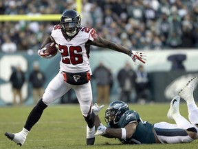 Atlanta Falcons' Tevin Coleman (26) slips past Philadelphia Eagles' Mychal Kendricks (95) during the first half of an NFL divisional playoff football game, Saturday, Jan. 13, 2018, in Philadelphia.
