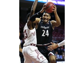 Cincinnati forward Kyle Washington (24) grabs a rebound away from Temple center Damion Moore (23) during the first half of an NCAA college basketball game, Thursday, Jan. 4, 2018, in Philadelphia.