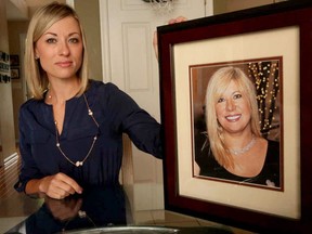 In this May 25, 2016, photo, Kim Pack poses with a photo of her late mother, talk-show host April Kauffman, in Linwood, N.J.