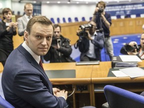 Russian opposition activist Alexei Navalny poses for photographers prior to a hearing at the European Court of Human Rights in Strasbourg, eastern France. Wednesday, Jan. 24, 2018. The European Court of Human Rights holds a hearing into whether Russia violated the rights of opposition leader Alexei Navalny through numerous arrests.