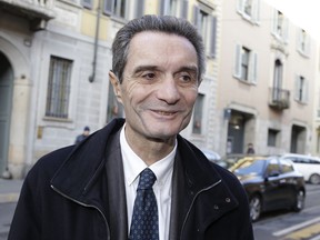 FILE - In this Thursday, Jan. 11, 2018 file photo, Attilio Fontana arrives for a news conference at the Palazzo ex Stelline, in Milan, Italy.  Fontana, running for governor in the affluent Lombardy region and backed by a center-right alliance, sparked outrage Monday Jan. 15, 2018, including from political opponents and Jewish leaders who recalled anti-Jewish racial laws enacted by Benito Mussolini's fascist dictatorship, after he said to a local radio on Sunday that Italy must decide "if our white race, our society, must continue to exist or be canceled out."
