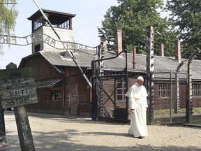 FILE - In this July 29, 2016 file photo, Pope Francis walks through the gate of the former Nazi German death camp of Auschwitz in Oswiecim, Poland. Pope Francis says countries have a responsibility to fight anti-Semitism and the "virus of indifference" threatening to erase the memory of the Holocaust.