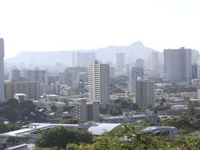 Diamond Head, an extinct volcanic crater, and high-rises are seen in Honolulu on Saturday, Jan. 13, 2018. A push alert that warned of an incoming ballistic missile to Hawaii and sent residents into a full-blown panic was a mistake, state emergency officials said.