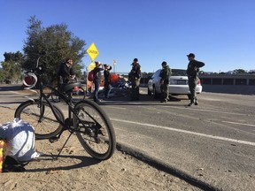 Homeless residents ask Orange County sheriff's deputies about the plan to clear their riverbed encampment in Anaheim, Calif., Monday, Jan. 22, 2018. Southern California authorities on Monday went tent to tent telling the homeless they're shutting down the large riverbed encampment some have called home for years.