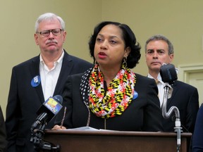 Delegate Joseline Pena-Melnyk, D-Md., discusses plans for legislation to create an individual mandate for health care at the state level and turn it into a down payment for people to get health insurance in the state during a news conference Tuesday, Jan. 9, 2018, in Annapolis, Md. State Sen. Jim Rosapepe is standing left and Sen. Brian Feldman is standing right.