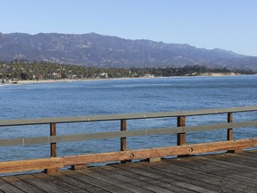 In this Nov. 18, 2016, photo, the coastline of Santa Barbara, left, and Montecito, right, is seen from Stearn's Wharf in Santa Barbara, Calif., a little over a year before a huge wildfire burned through the Santa Ynez Mountains and then a storm's downpours unleashed devastating mudslides. Officials say the possibility of future catastrophic floods will be in mind as Montecito rebuilds following deadly mudslides that devastated the wealthy coastal hideaway. While an aggressive cleanup could mean Montecito will welcome visitors again in weeks, the rebuilding of infrastructure and hundreds of homes will take months or years.