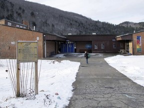 In this Dec. 11, 2017 photo, a student walks toward the Rochester School in Rochester, Vt. The middle-high school is slated to close at the end of the 2018 school year, as Rochester is among some small rural communities struggling to keep schools open in the face of dropping enrollment, rising costs and tightening budgets.