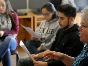 In this Jan. 18, 2018, photo, high school seniors John King, second from right, Ashley Zapata, second from left, and Felicity Sealy, left, listen as English and college-preparation teacher Rhonda Gardner leads a discussion about how to adjust to the academic, financial and social pressures of collegiate life on Thursday, Jan. 18, 2018, in Santa Fe, N.M.