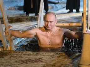 Russian President Vladimir Putin bathes in ice cold water on Epiphany near St. Nilus Stolobensky Monastery on Lake Seliger in Svetlitsa village, Russia. 
Thousands of Russian Orthodox Church followers will plunge into icy rivers and ponds across the country to mark Epiphany, cleansing themselves with water deemed holy for the day.