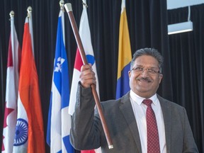 Captain Rakesh Kumar, of the Ottawa Express container ship, holds up the 179th gold cane award for the first ship to arrive in the new year at a ceremony Wednesday, January 3, 2018 in Montreal.