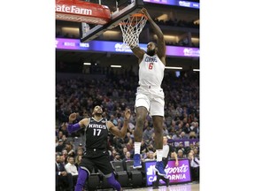 Los Angeles Clippers center DeAndre Jordan, right, stuffs over Sacramento Kings guard Garrett Temple game Thursday, Jan. 11, 2018, in Sacramento, Calif.