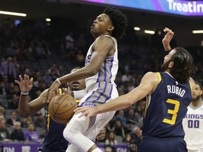 Sacramento Kings guard De'Aaron Fox, left, has the ball hit out of his hands by Utah Jazz guard Ricky Rubio during the first quarter of an NBA basketball game Wednesday, Jan. 17, 2018, in Sacramento, Calif.