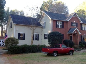 Cars are parked at a home in York, S.C. on Tuesday, Jan. 16, 2018, where multiple deputies responding to a domestic violence call were shot and wounded. State Law Enforcement Division spokesman Thom Berry said Christian Thomas McCall is the man officers think shot and wounded the officers early Tuesday.