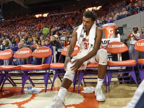 Clemson's Donte Grantham holds his knee after an injury during the second half of an NCAA college basketball game against Notre Dame Saturday, Jan. 20, 2018, in Clemson, S.C. Clemson won 67-58.