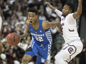 Kentucky guard Shai Gilgeous-Alexander (22) dribbles the ball against South Carolina guard Wesley Myers (15) during the first half of an NCAA college basketball game Tuesday, Jan. 16, 2018, in Columbia, S.C.