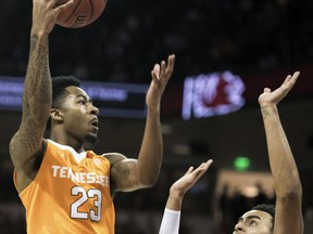 Tennessee guard Jordan Bowden (23) attempts to shoot against South Carolina forward Justin Minaya, right, during the first half of an NCAA college basketball game Saturday, Jan. 20, 2018, in Columbia, S.C.