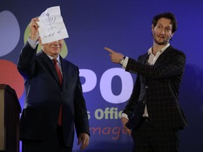 In this photo dated Wednesday, Jan. 10, 2018, Israeli mentalist Lior Suchard, right, gestures as he stands with Israeli Prime Minister Benjamin Netanyahu during the annual toast with the foreign media in Jerusalem.  Suchard went head to head with Netanyahu in front of a group of journalists, only to come up empty in an awkward duel with the Israeli leader.