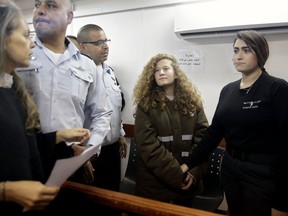 Ahed Tamimi is brought to a courtroom inside the Ofer military prison near Jerusalem, Monday, Jan. 15, 2018. An Israeli military court has extended the detention of a Palestinian teen filmed last month slapping soldiers.