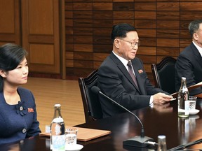 FILE - In this Jan. 15, 2018, file photo, in this photo provided by South Korea Unification Ministry, the head of North Korean delegation Kwon Hyok Bong, center, and Hyon Song Wol, the head of the Moranbong Band, left, sit during the meeting with South Korea at the North side of Panmunjom in North Korea. The head of North Korea's most popular girl band is visiting South Korea this weekend to check preparations for a trip by another Northern art troupe led by her as part of Pyongyang's Olympic delegation, officials said Friday.(South Korea Unification Ministry via AP, File)