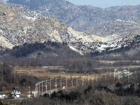 FILE - In this Jan. 23, 2018 file photo, a bus carrying South Korean advance team is escorted by South Korean military vehicles as a bus leaves for North Korea in Goseong, South Korea. South Korea says North Korea has cancelled one of key joint cooperation projects planned for next month's Winter Olympics in the South.