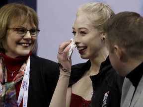 Bradie Tennell, center, reacts after performing during the women's short program at the U.S. Figure Skating Championships in San Jose, Calif., Wednesday, Jan. 3, 2018.