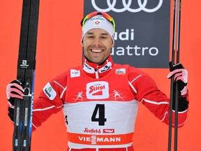 Alex Harvey celebrates on the podium after finishing second in the Men's FIS Cross Country 15 km nass start World Cup race in Seefeld, Austria, on Jan. 28.