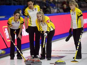 Manitoba third Shannon Birchard, left, to right, second Jill Officer, skip Jennifer Jones, and lead Dawn McEwen talk out their play during a timeout while taking on Northern Ontario at the Scotties Tournament of Hearts in Penticton, B.C., on Wednesday, Jan. 31, 2018.