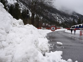 A road near the German-Austrian frontier is closed because of the danger of avalanches near Mittenwald-Scharnitz, Germany, Tuesday, Jan. 23, 2018.