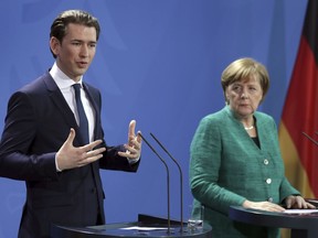 German Chancellor Angela Merkel, right, and the Chancellor of Austria Sebastian Kurz, left, address the media during a joint press conference after a meeting at the chancellery in Berlin, Germany, Wednesday, Jan. 17, 2018.