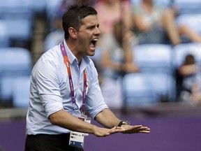 In this Aug. 9, 2012 file photo, John Herdman coaches the Canadian women's soccer team in the bronze-medal match of the London Olympics.