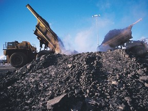 Two heavy haulers unload at the Suncor oilsands mine in a file photo from 2007.