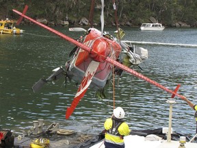 In this Jan. 4, 2018, photo provided by the Australian Transport Safety Bureau (ATSB), wreckage of a seaplane is lifted from a river north of Sydney. The owner of the seaplane that crashed near Sydney during a New Year's Eve joy flight, killing the Canadian pilot and his five British passengers, says that flight path was not authorized according to a preliminary report released Wednesday, Jan. 31, 2018, by the Australian Transport Safety Bureau. (ATSB via AP)