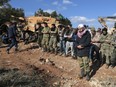 Pro-Turkey Syrian fighters pray after they secured the Bursayah hill, which separates the Kurdish-held enclave of Afrin from the Turkey-controlled town of Azaz, Syria, Sunday, Jan. 28, 2018.