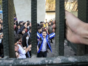 FILE - In this Dec. 30, 2017 file photo, taken by an individual not employed by the Associated Press and obtained by the AP outside Iran, university students attend an anti-government protest inside Tehran University, in Tehran, Iran. As nationwide protests have shaken Iran over the last week, the Islamic Republic increasingly has blamed its foreign foes for fomenting the unrest. So far though, there's no direct evidence offered by Tehran to support that claim. (AP Photo, File)