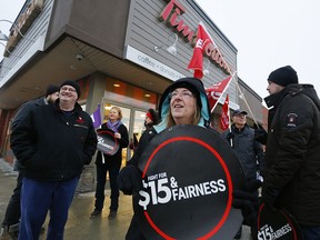 Protesters gather outside a Tim Hortons restaurant in Peterborough, Ont., on Jan. 10, 2018.
