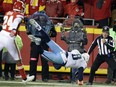 Tennessee Titans quarterback Marcus Mariota leaps over the goal line for a touchdown in front of Chiefs defensive back Will Redmond during the second half of their AFC wild-card playoff game in Kansas City, Mo., on Saturday.