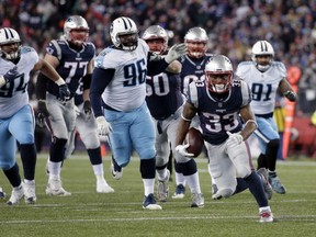 New England Patriots running back Dion Lewis carries the ball against the Tennessee Titans during the first half of NFL divisional playoff game on Saturday in Foxborough, Mass.