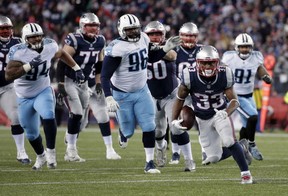 New England Patriots running back Dion Lewis carries the ball against the Tennessee Titans during the first half of NFL divisional playoff game on Saturday in Foxborough, Mass.