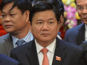 In this Jan. 28, 2016, photo, newly elected Politburo member Dinh La Thang poses on the podium along with all others new Vietnam Communist Party's central committee members at the closing ceremony of the party's national congress in Hanoi, Vietnam. Vietnam has begun a major corruption trial against defendants who include the former senior Communist official and a former oil executive the Vietnamese government is accused of snatching from Germany. Dinh La Thang is accused of mismanagement in a thermal power plant.